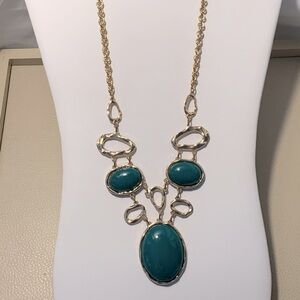 Green “Stones” In A Gold Setting.